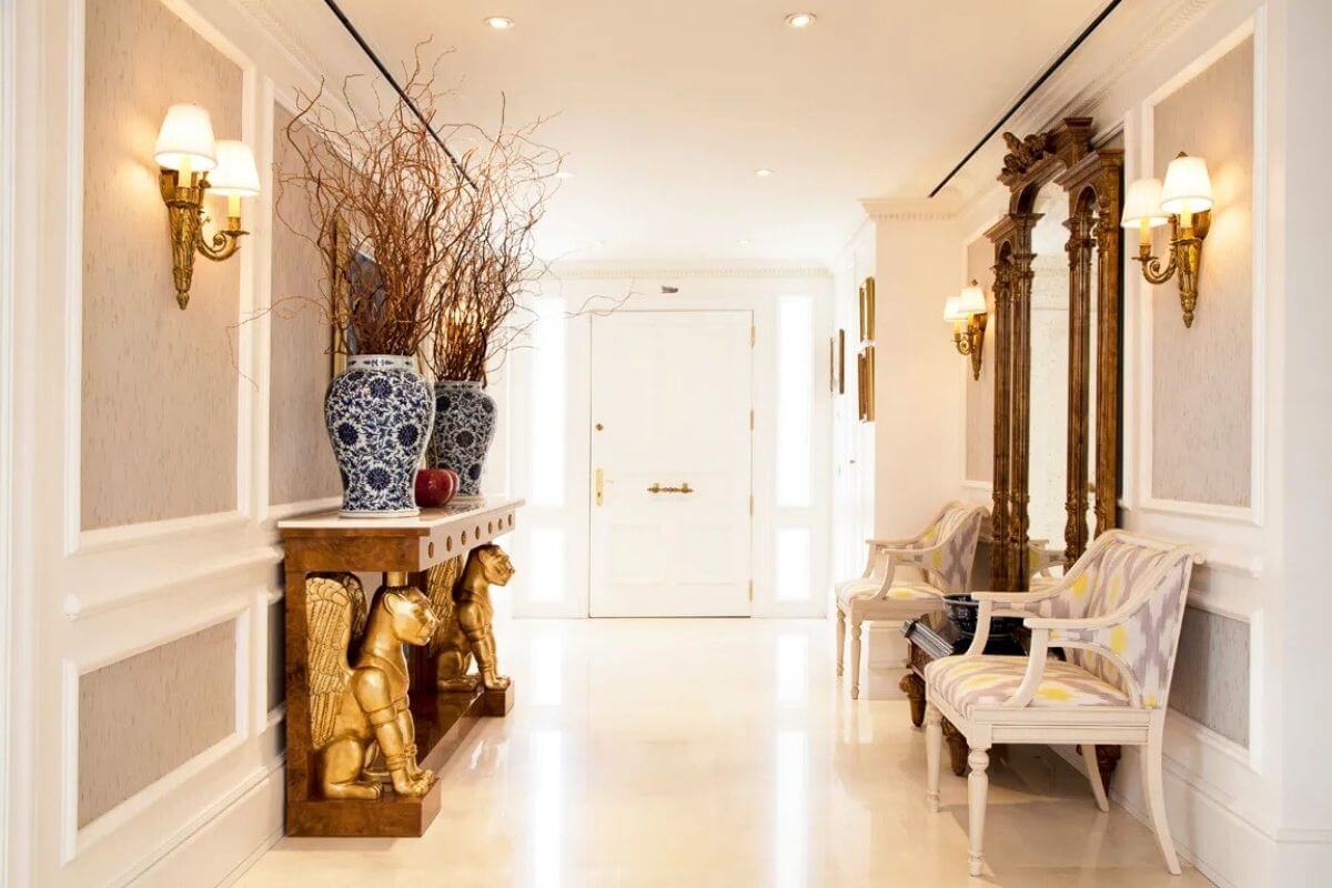 A bright and welcoming home entryway decorated with a pastel doormat, a small potted plant, and soft spring accents.