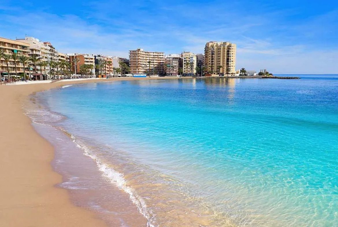 Contemporary beachside apartments for sale in Spain, just 100 meters from the Mediterranean, with modern design, balconies, and excellent location.