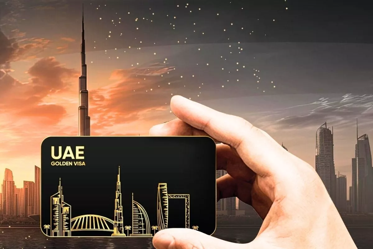 Dubai Golden Visa real estate investment concept showing passport, skyline, and luxury homes.